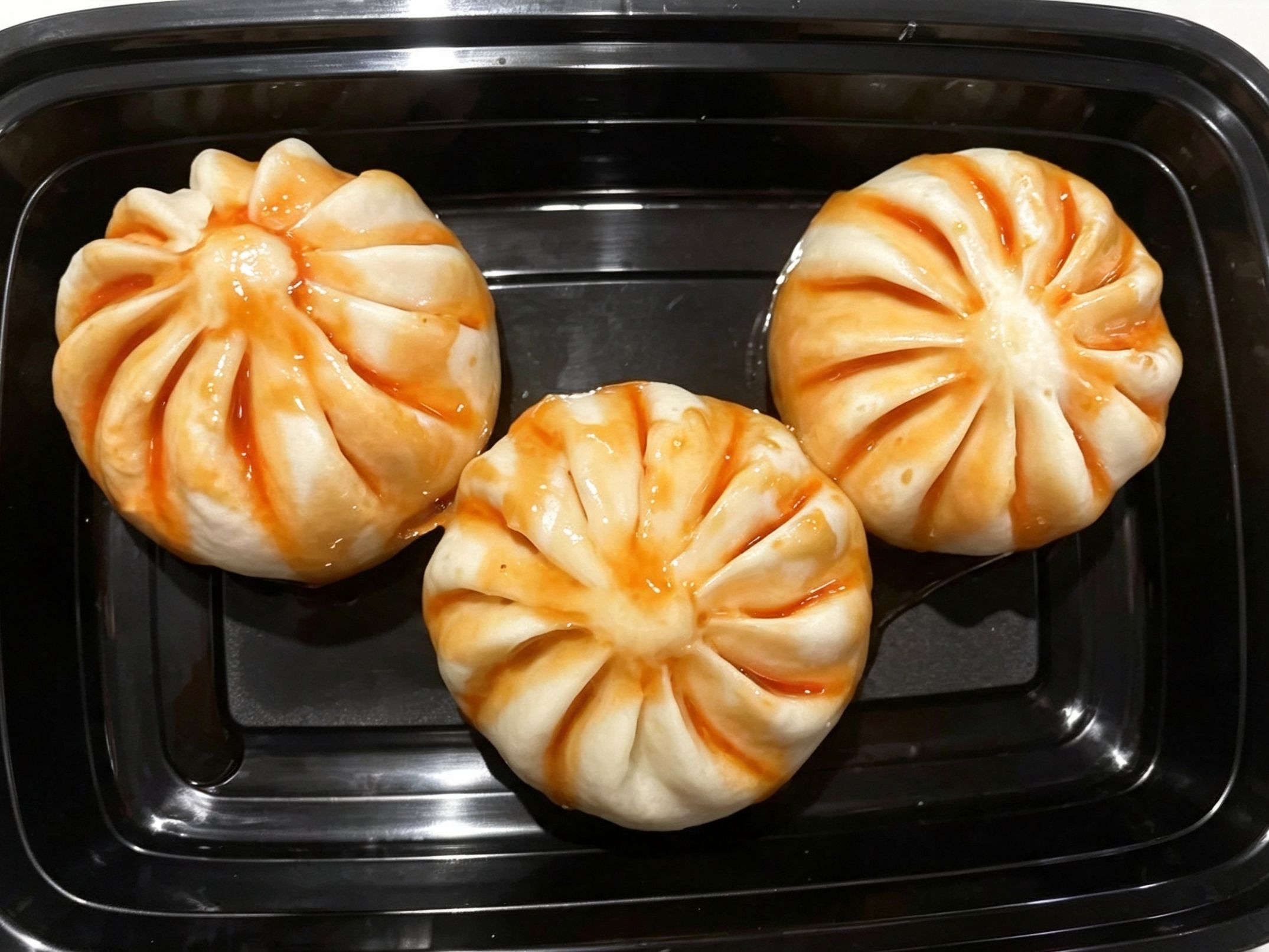 Three glossy barbecue pork steamed buns at China Fortune | Chinese Food，a Chinese Restaurant in Layton