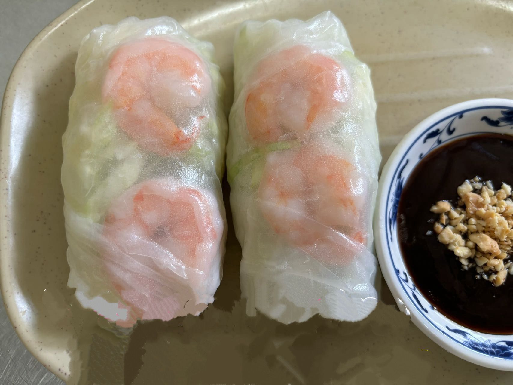 Two fresh shrimp rice paper spring rolls with dark peanut dipping sauce at The Wok, an Asian Fusion Restaurant in Rochester