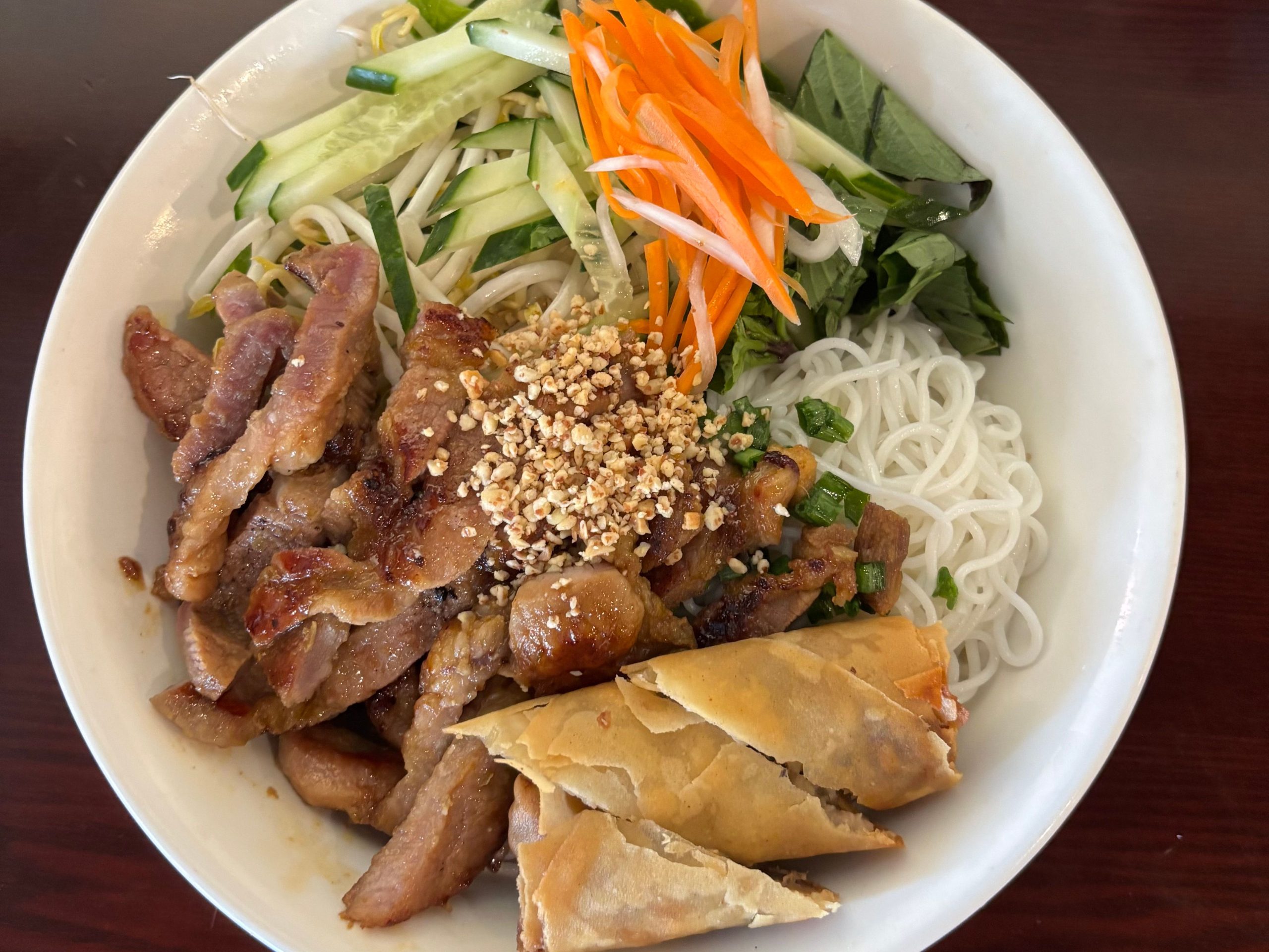 Vietnamese pork noodle salad plate with fried spring roll and shredded veggies at The Wok, an Asian Fusion Restaurant in Rochester