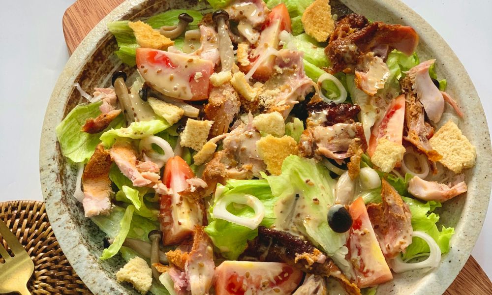 Ceramic bowl of classic Caesar salad with romaine, smoked turkey, tomato, mushrooms and crunchy croutons at Zen Bowl, a Healthy Poke Restaurant in Imperial