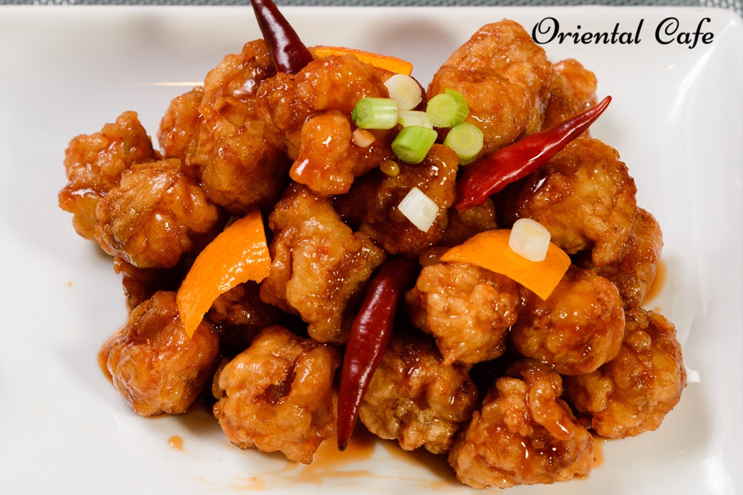Crispy orange chicken with orange slices and chilies at Oriental Cafe, a Chinese Restaurant in Rockville