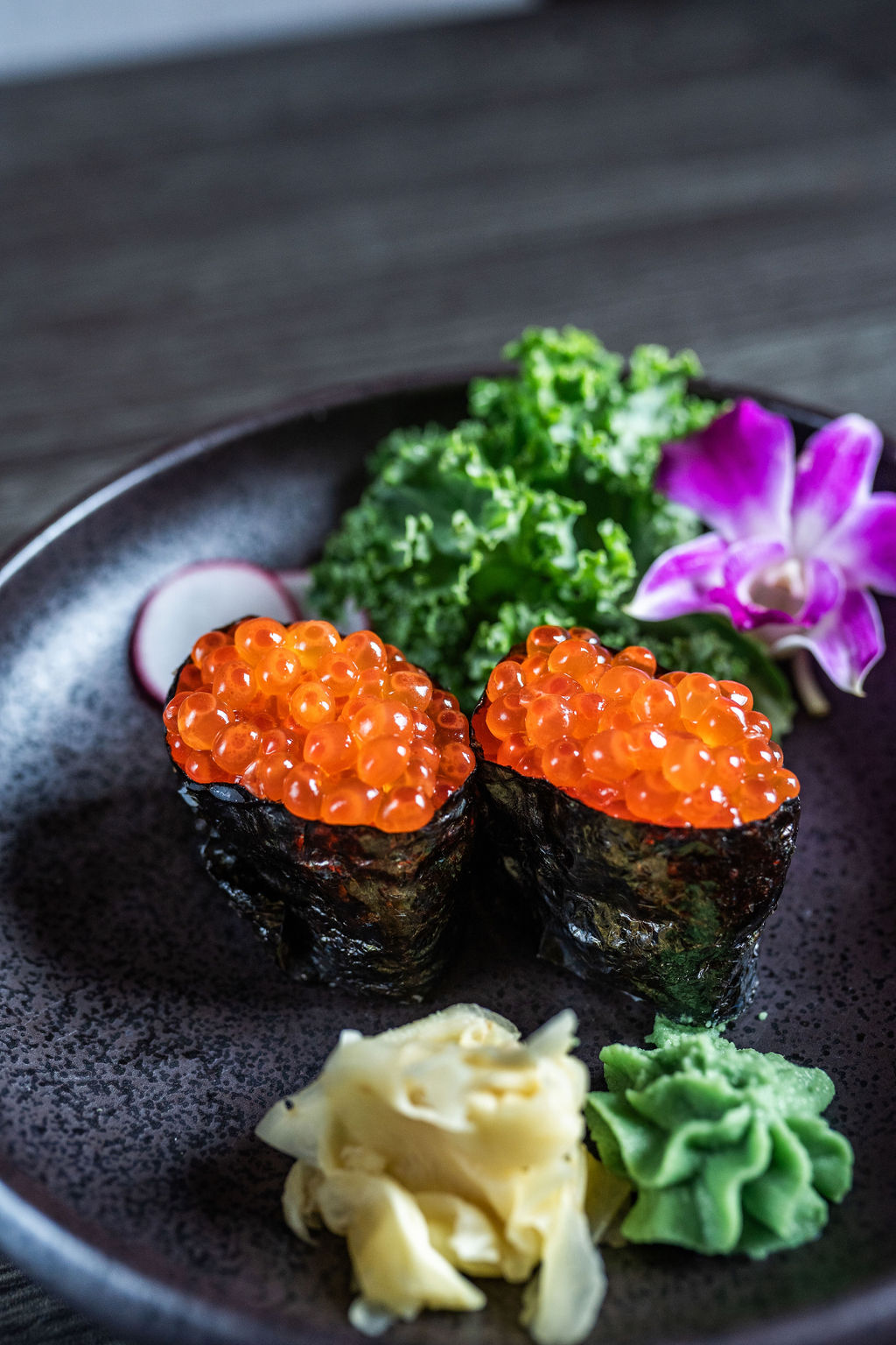 Ikura salmon roe gunkan maki sushi with garnishes at Origami Asian Fusion Exton, an Asian Fusion Restaurant in Exton