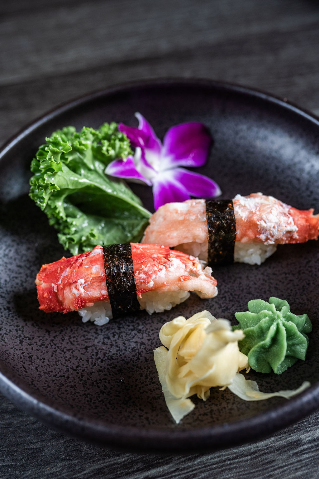 King crab nigiri sushi pieces with garnishes at Origami Asian Fusion Exton, an Asian Fusion Restaurant in Exton