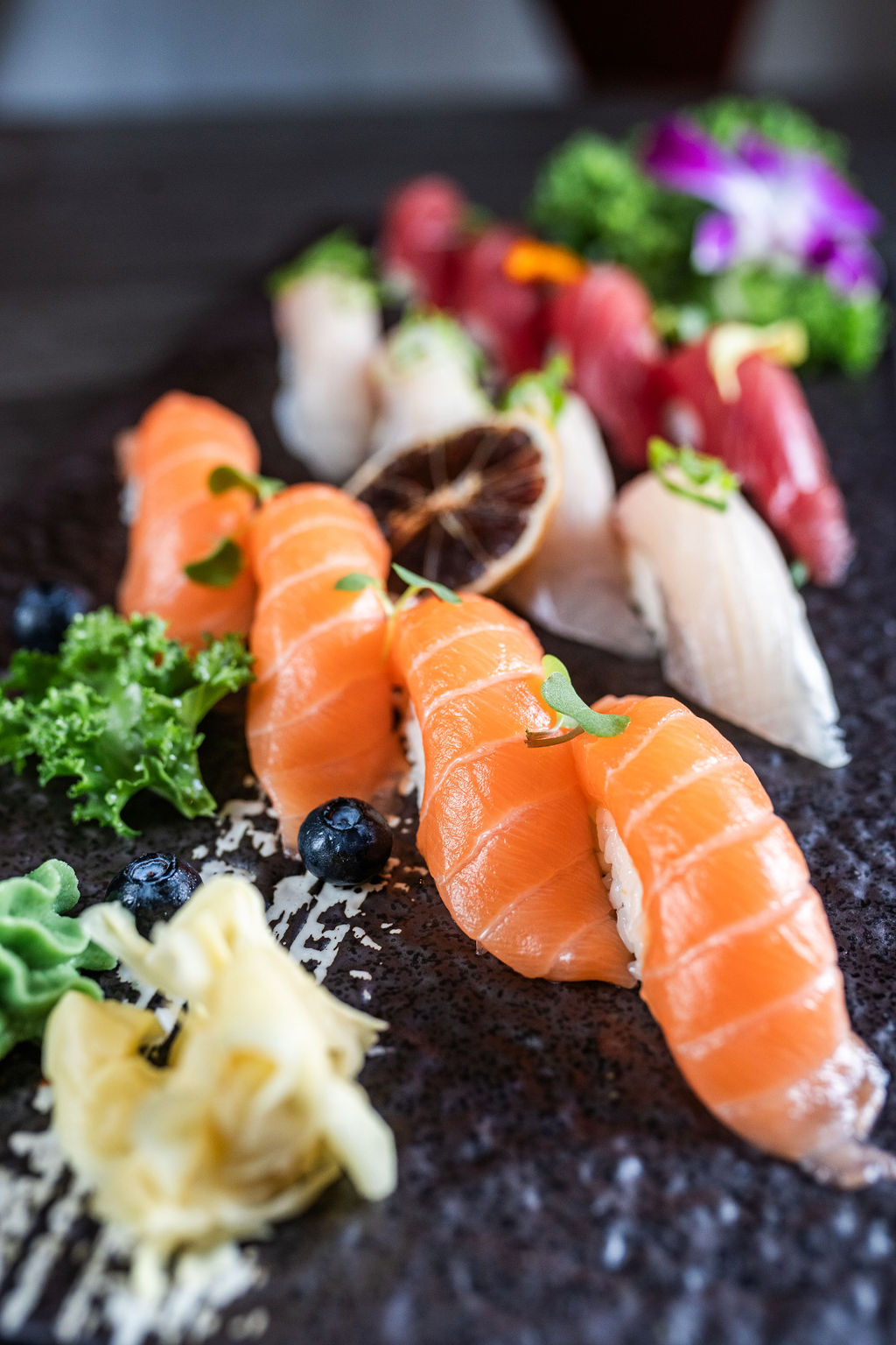Salmon nigiri sushi platter with mixed fish and garnishes at Origami Asian Fusion Exton, an Asian Fusion Restaurant in Exton