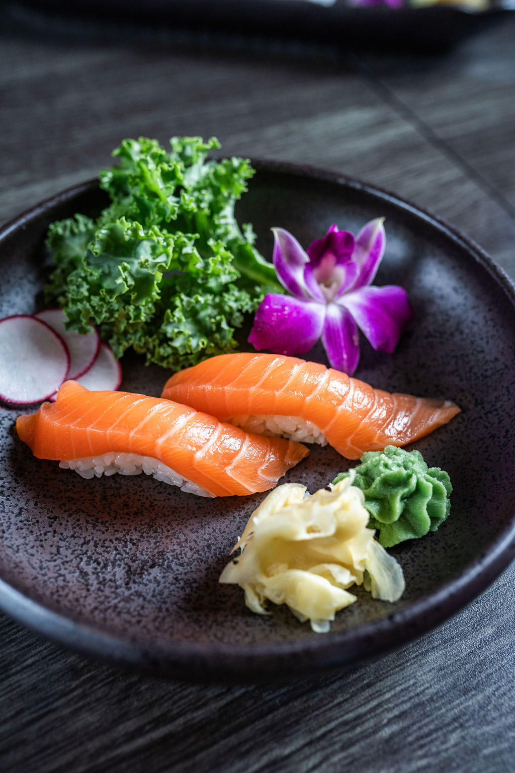 Two pieces of salmon nigiri sushi with garnishes at Origami Asian Fusion Exton, an Asian Fusion Restaurant in Exton