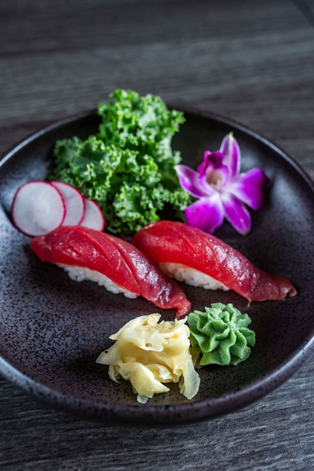 Two pieces of tuna nigiri sushi with garnishes at Origami Asian Fusion Exton, an Asian Fusion Restaurant in Exton