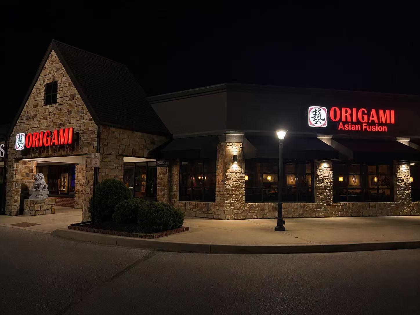 Night exterior photo of stone Origami Asian Fusion restaurant building with lit signage at Origami Asian Fusion Exton, an Asian Fusion Restaurant in Exton