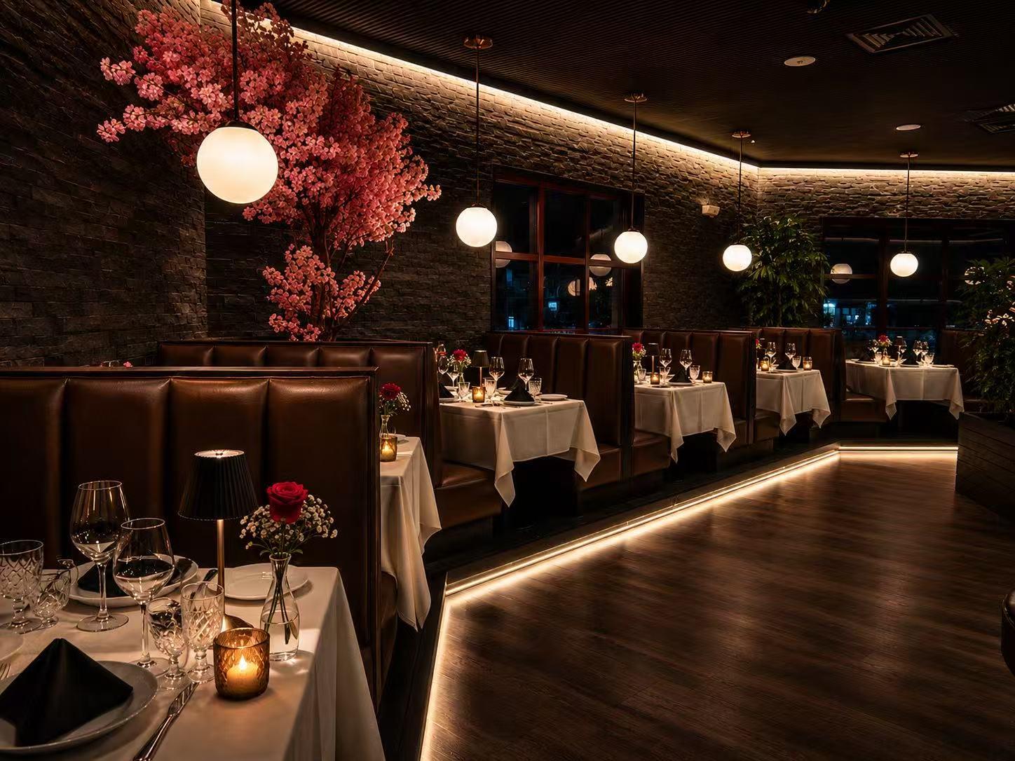 Dining booth area featuring pink cherry blossom wall decor and round globe pendant lights at Origami Asian Fusion Exton, an Asian Fusion Restaurant in Exton