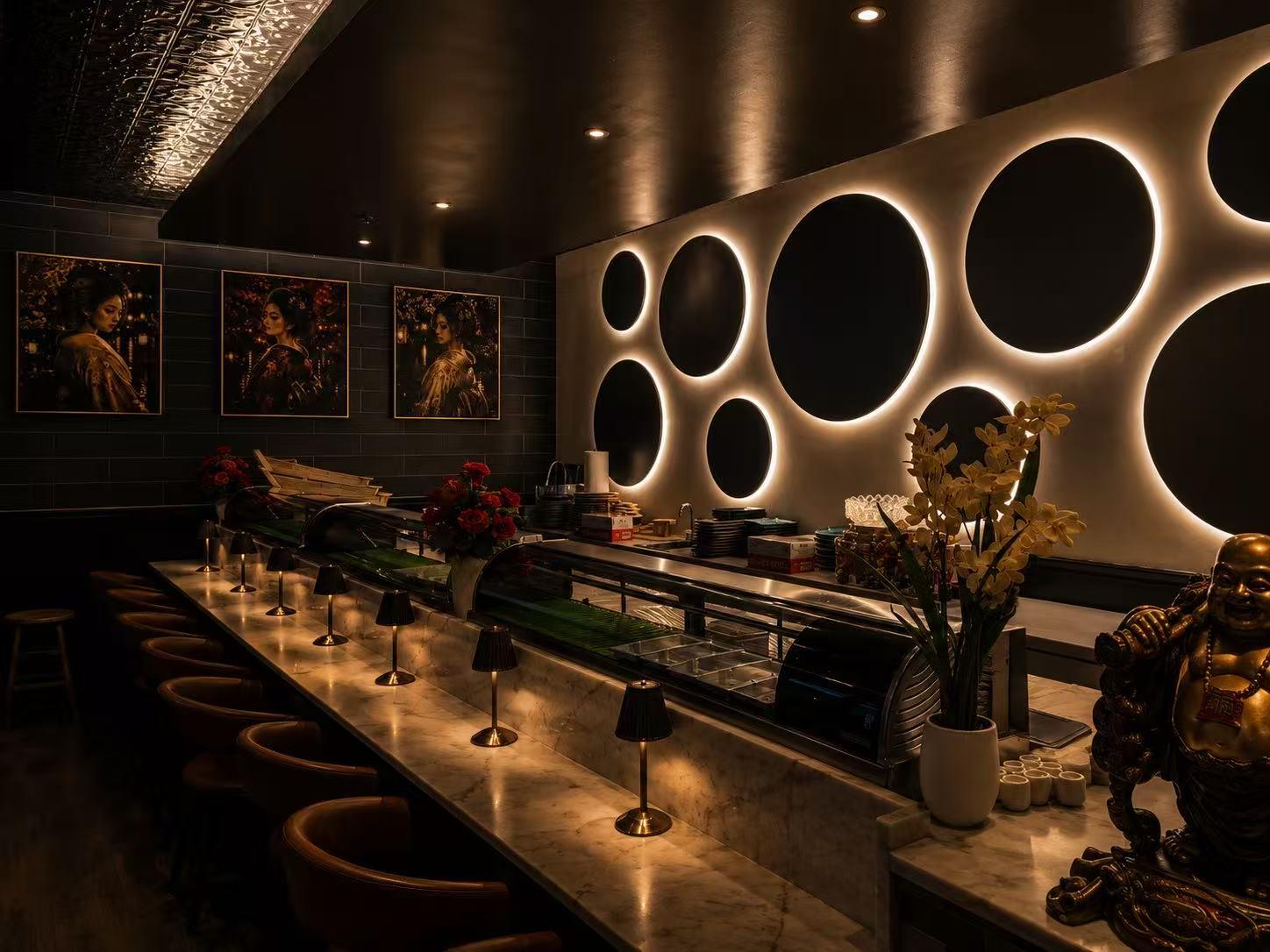 Modern dark wood sushi bar and dining room interior with circular wall decor at Origami Asian Fusion Exton, an Asian Fusion Restaurant in Exton