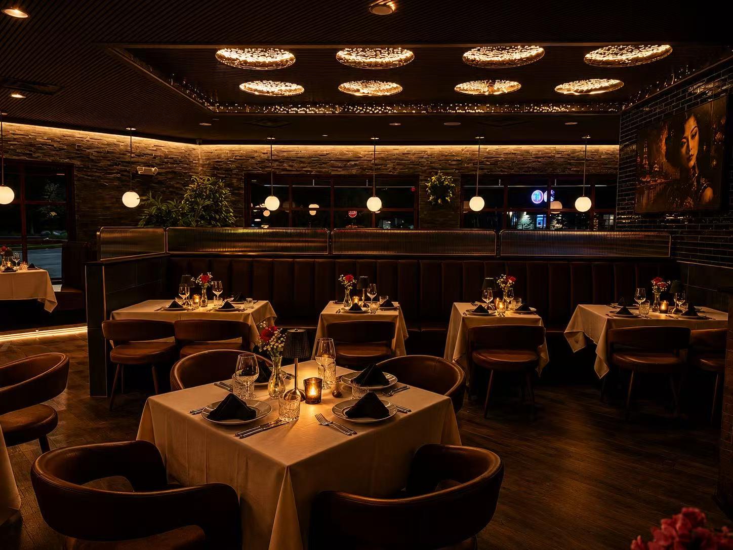 Dimly lit elegant main dining room with set tables, booths and glowing ceiling lights at Origami Asian Fusion Exton, an Asian Fusion Restaurant in Exton
