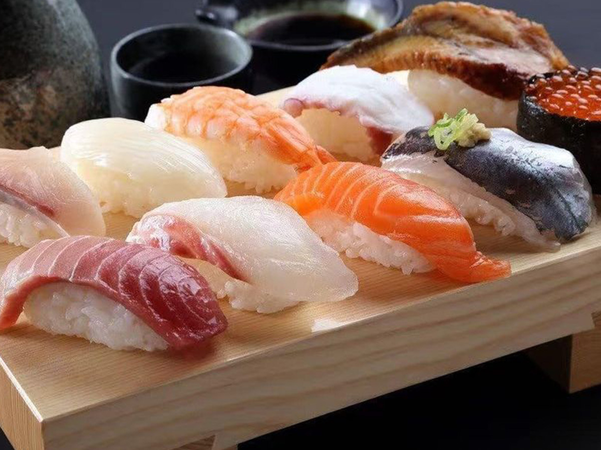 Assorted Sushi A variety of sushi pieces including salmon, tuna, and shrimp on a wooden board at Oroshi Sushi Omakase, a Japanese restaurant in Philadelphia