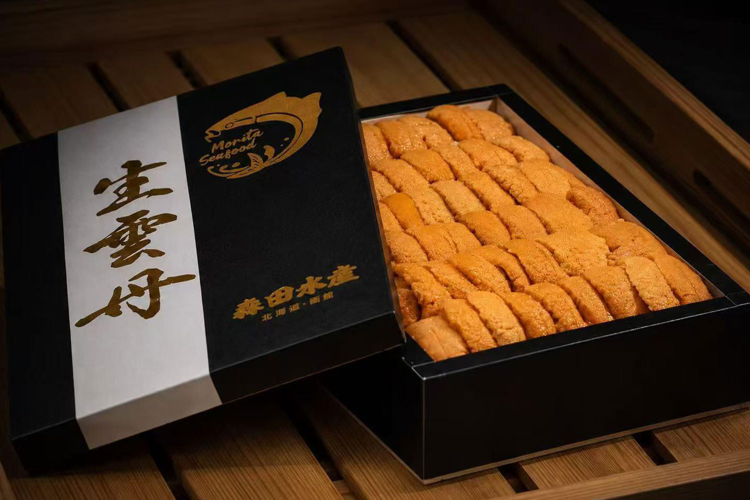 Open black gift box filled with premium Hokkaido sea urchin roe with gold Japanese branding at Oroshi Sushi Omakase , a Japanese Restaurant in Philadelphia