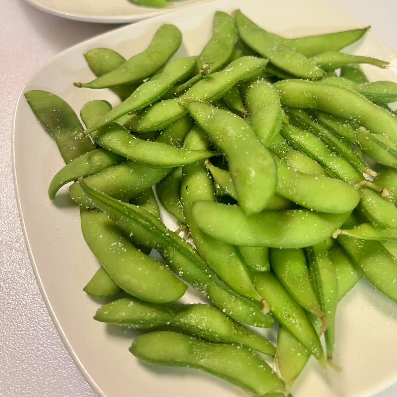 Fresh edamame sprinkled with salt at OSAKA Japanese Cuisine, a Japanese Restaurant in Buffalo