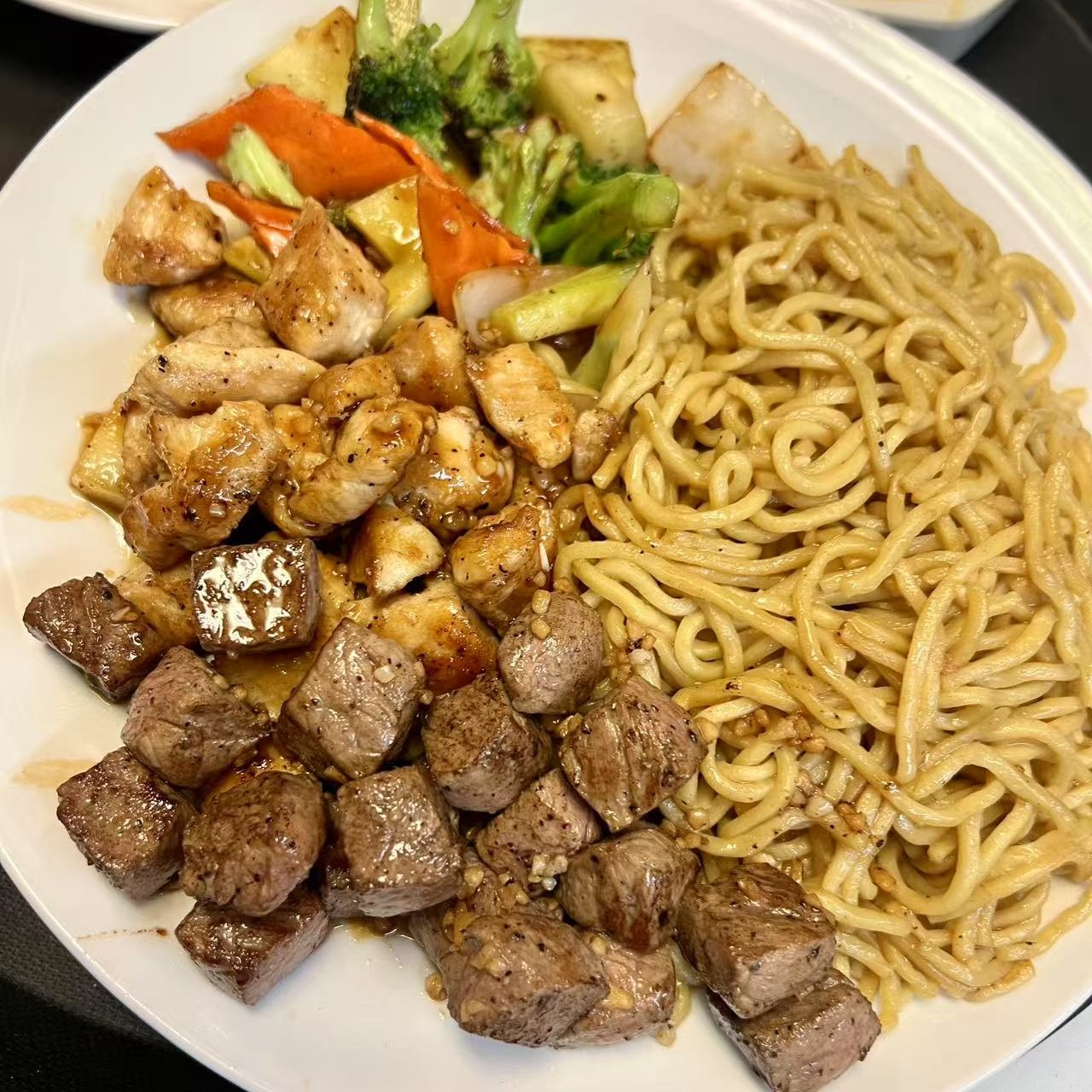 Chicken and steak served with noodles and mixed vegetables at OSAKA Japanese Cuisine, a Japanese Restaurant in Buffalo