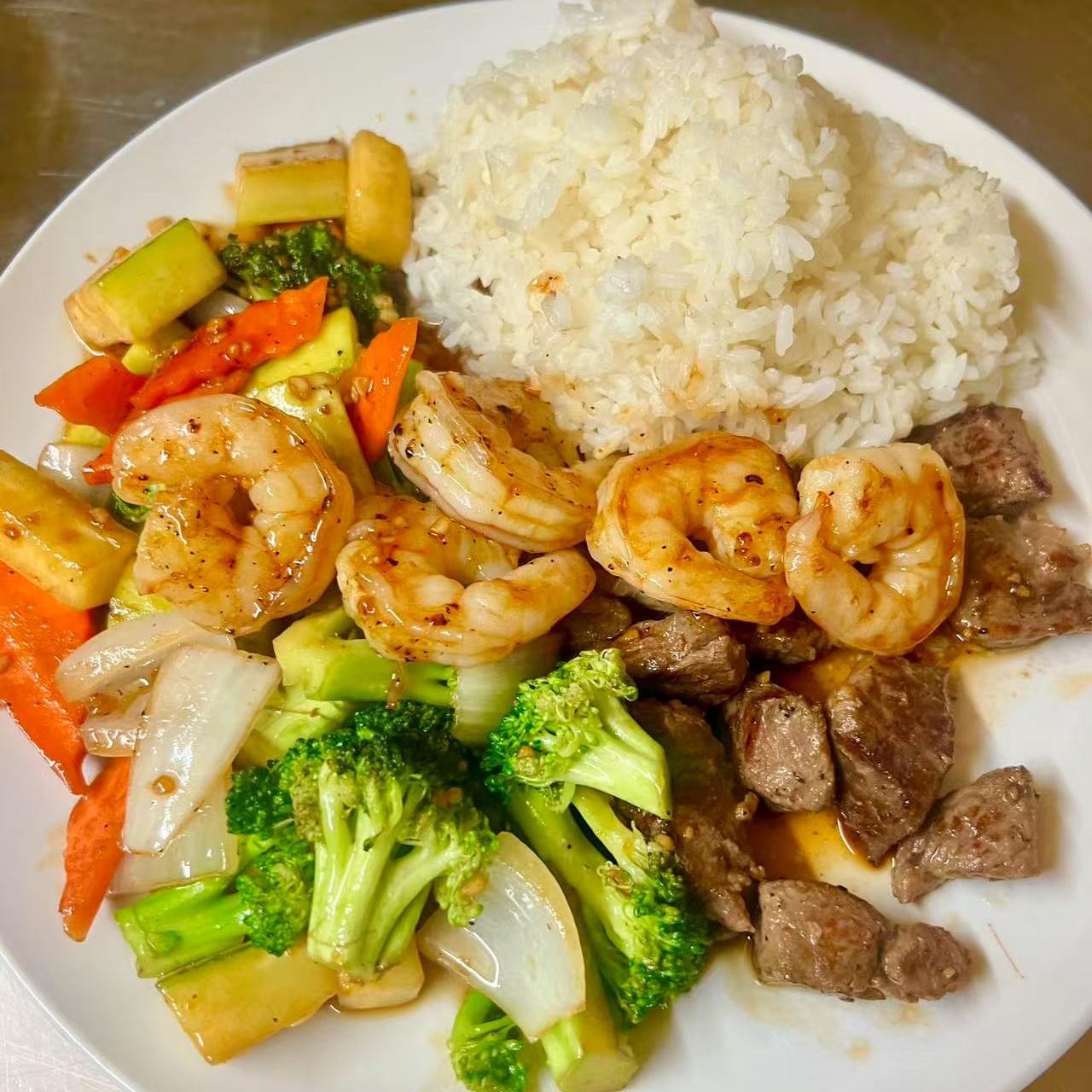 Steak and shrimp served with rice and mixed vegetables at OSAKA Japanese Cuisine, a Japanese Restaurant in Buffalo
