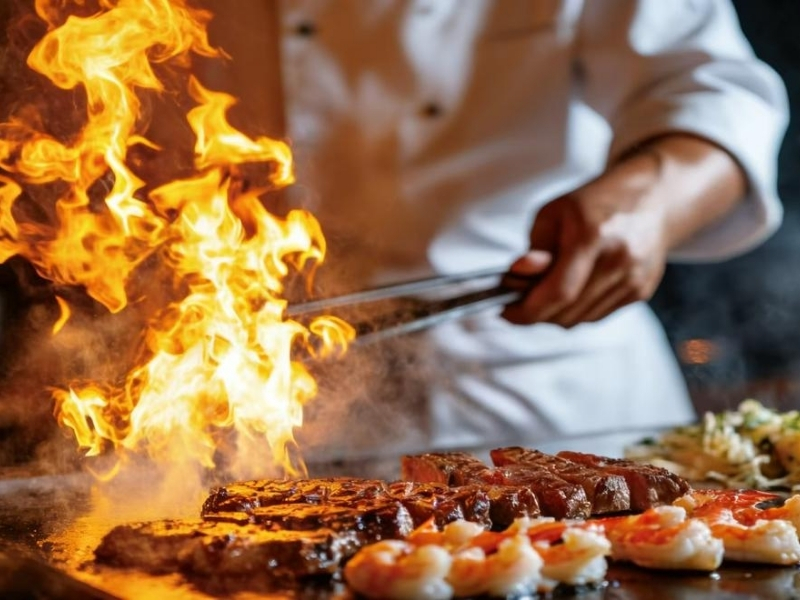 Dramatic hibachi grilling with flames at Osaka Sushi Hibachi Asian Kitchen, a Asian Restaurant in Lake City