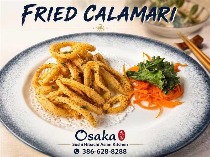 Golden fried calamari rings with seasoned garnish and fresh shredded carrots at Osaka Sushi Hibachi Asian Kitchen, a Asian Restaurant in Lake City