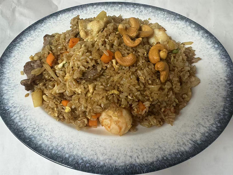 Mixed fried rice with shrimp, beef, chicken, cashews, and diced vegetables on a plate at Osaka Sushi Hibachi Asian Kitchen, a Asian Restaurant in Lake City