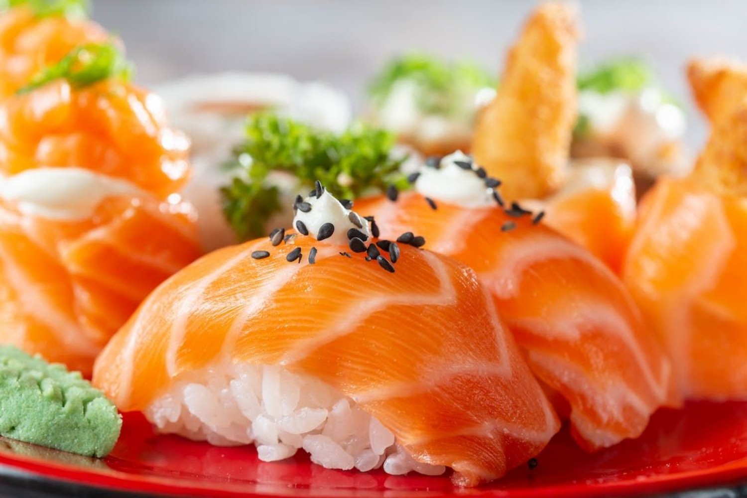 Salmon nigiri garnished with black sesame seeds at Osake，a Japanese Restaurant in Covington