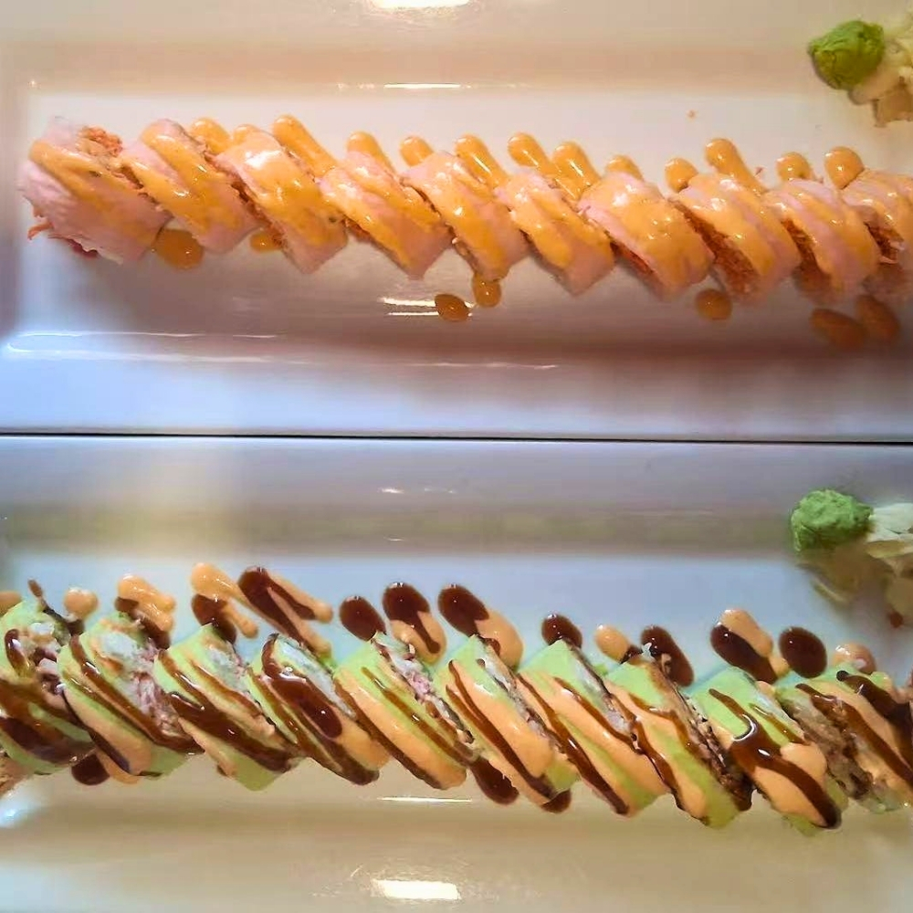Colorful sushi rolls with various sauces at Osaki Japanese Restaurant, a Japanese Restaurant in Hays