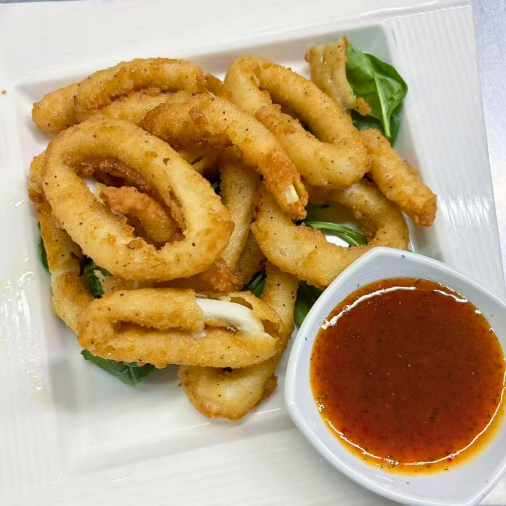 Crispy fried calamari rings with dipping sauce at Osaki Japanese Restaurant, a Japanese Restaurant in Hays