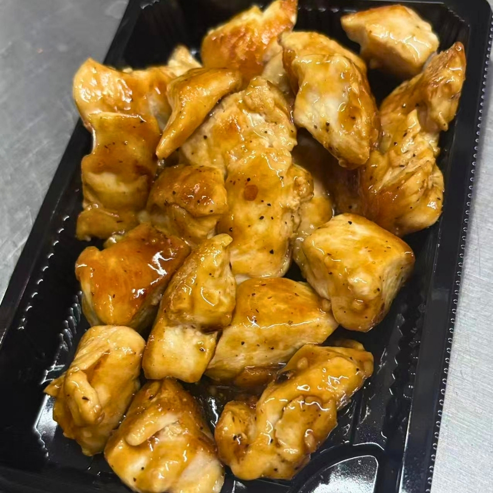 Glazed teriyaki chicken chunks in takeout box at Osaki Japanese Restaurant, a Japanese Restaurant in Hays
