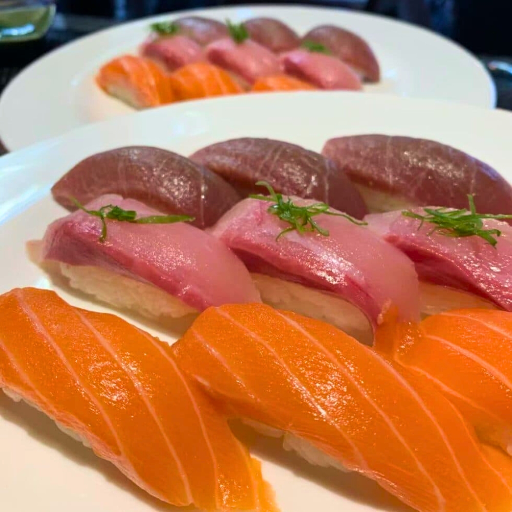 Assorted tuna and salmon nigiri sushi on white plate