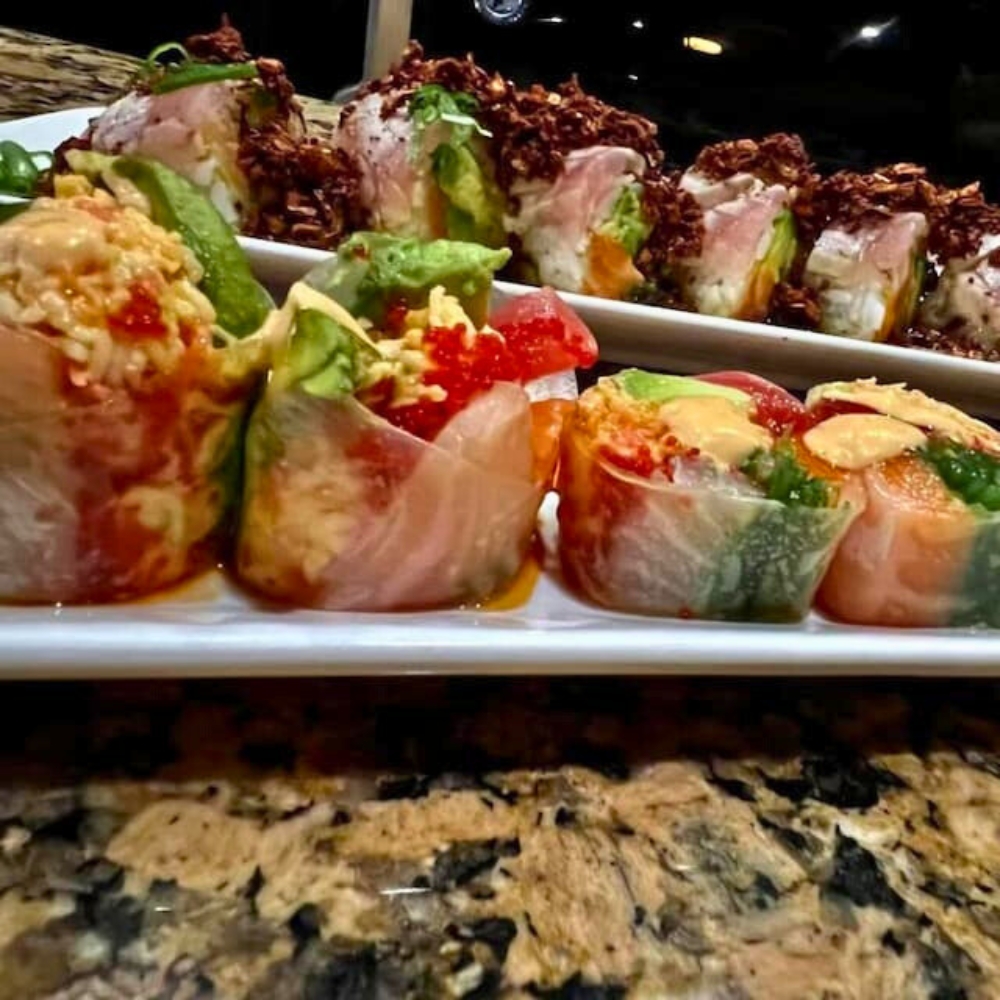 Creative tuna and salmon maki rolls with avocado