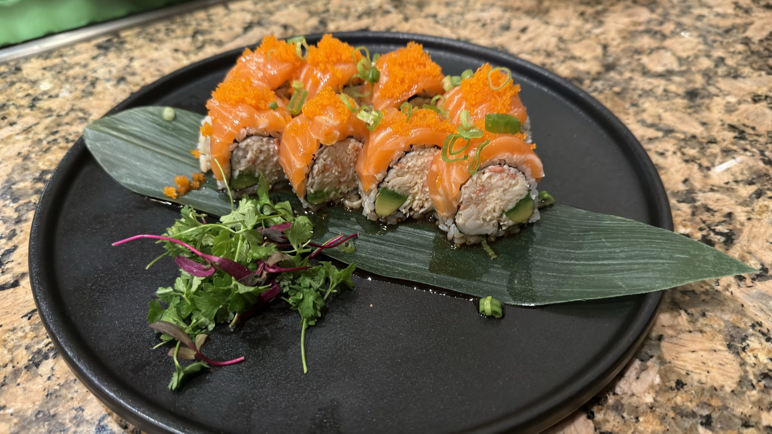 Salmon roll with tobiko on black plate at Pacific Asian Bistro, a Japanese Restaurant in St. Augustine Salmon roll with tobiko on black plate at Pacific Asian Bistro, a Japanese Restaurant in St. Augustine
