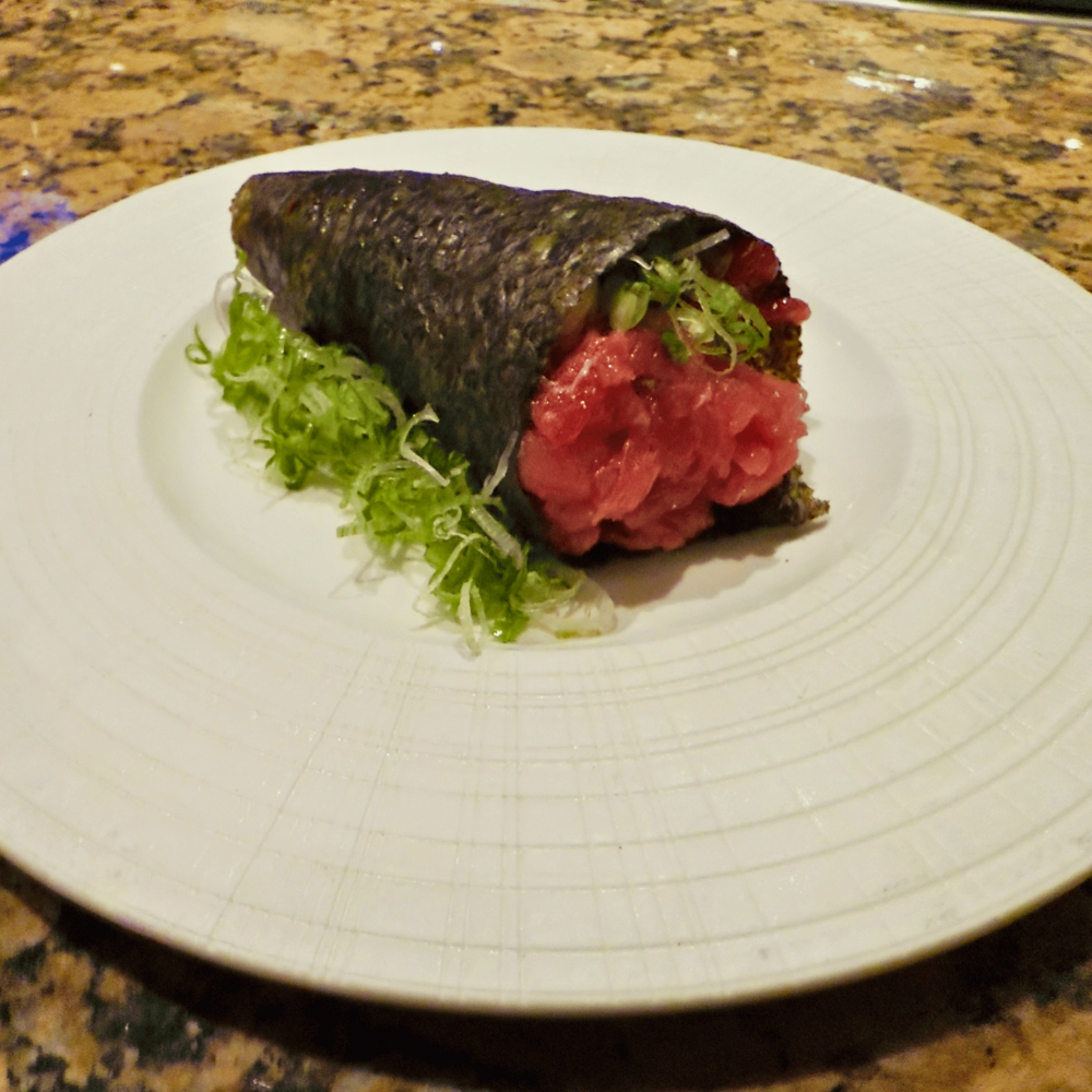 Tuna tartare hand roll with seaweed and greens