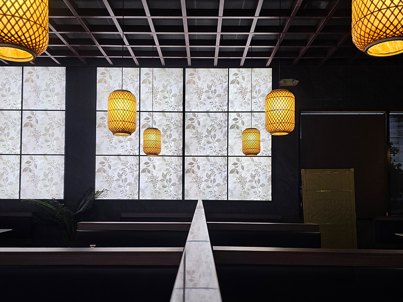 Warm bamboo lanterns and floral panels in dining area at Pakusan Sushi & Grill, a Japanese Restaurant in Chandler
