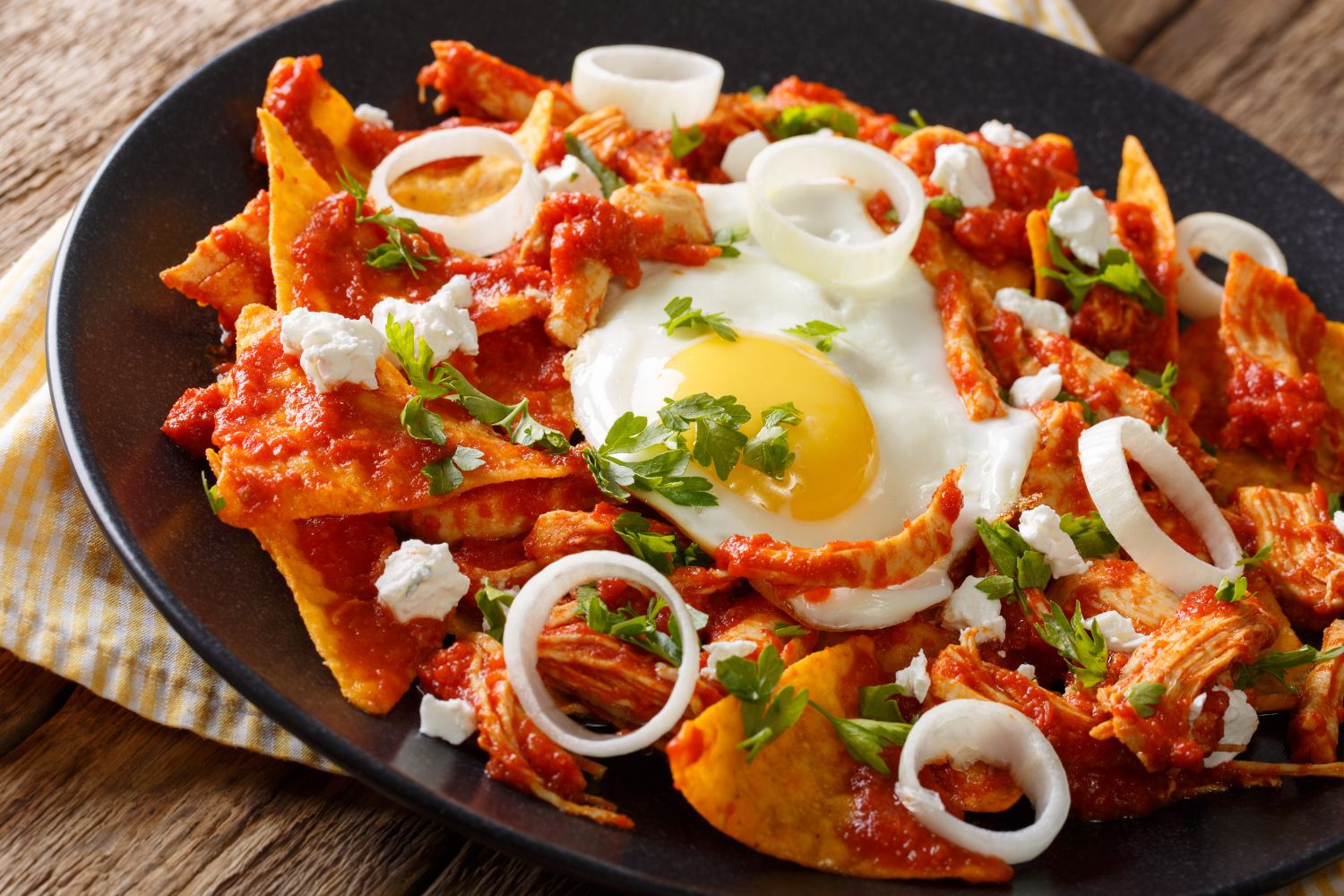 Chilaquiles with fried egg and red salsa at Panadería Corona, a Mexican Style Restaurant in Houston