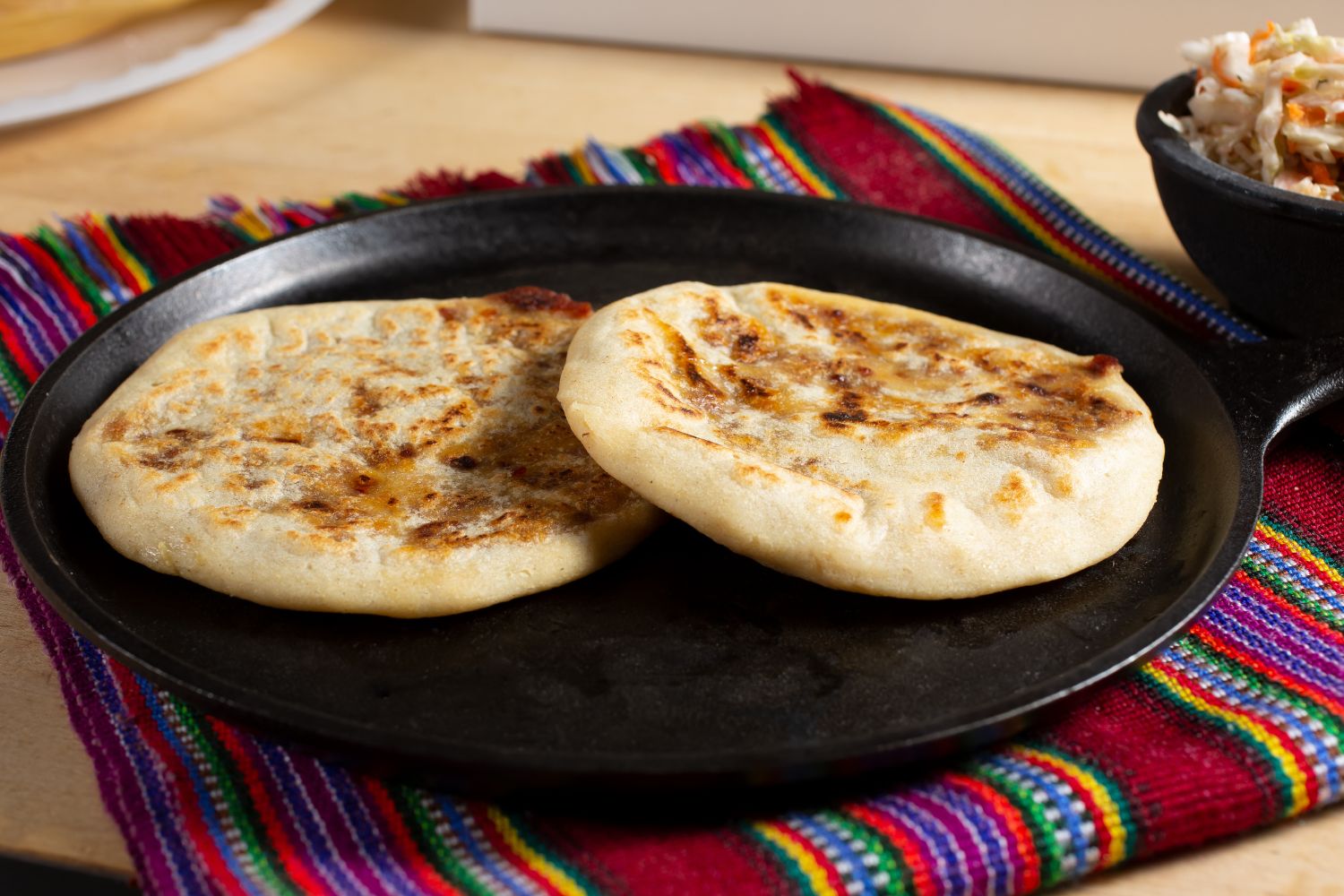 Grilled pupusas on a cast iron pan at Panadería Corona, a Mexican Style Restaurant in Houston