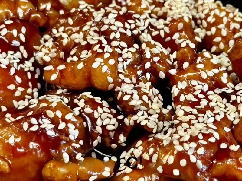 Crispy chicken coated in sweet sauce and sprinkled with sesame seeds at Panda Buffet Chinese Food, a Chinese Restaurant in Willoughby