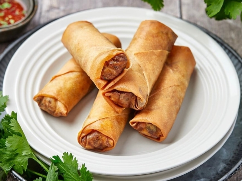 Golden crispy egg rolls served with fresh cilantro at Panda Hibachi, a Chinese Restaurant in Duncan