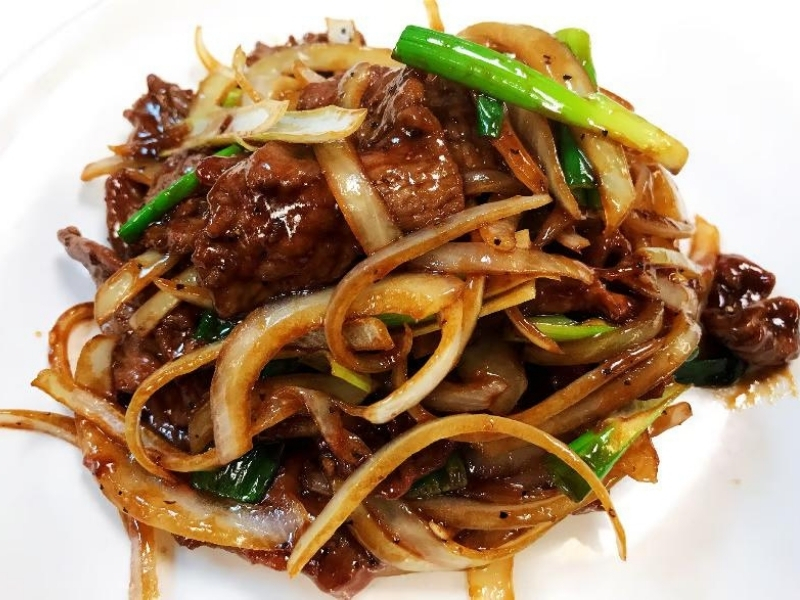 Savory beef stir-fry with onions and green scallions at Panda Hibachi, a Chinese Restaurant in Duncan