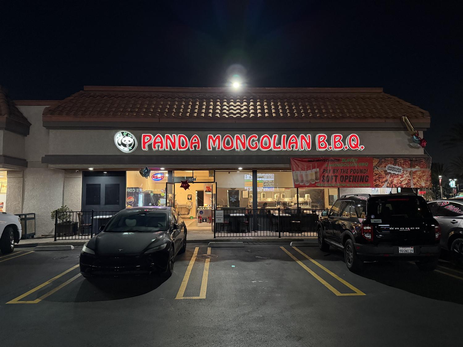 Night exterior facade of Panda Mongolian BBQ with neon signage at Panda Mongolian BBQ, a Chinese Restaurant in Orange