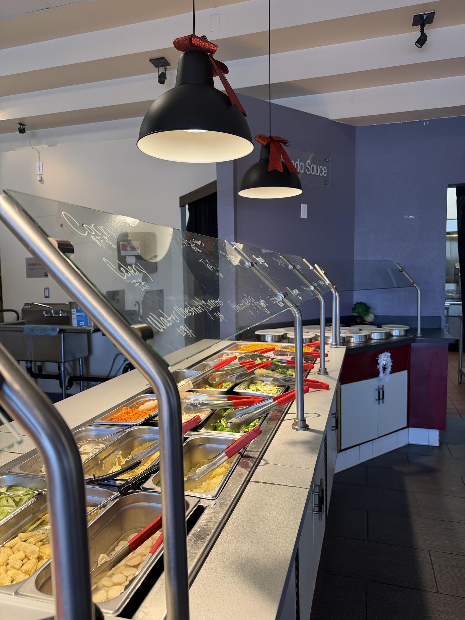 Ingredient bar display with veggies & utensils at Panda Mongolian BBQ, a Chinese Restaurant in Orange