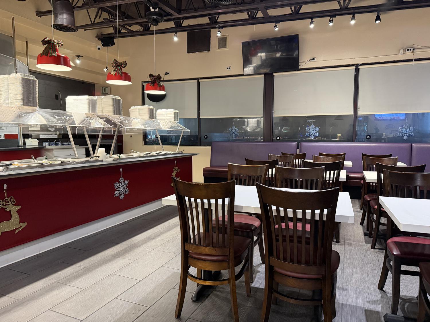 Dining area with tables, chairs & adjacent food bar at Panda Mongolian BBQ, a Chinese Restaurant in Orange
