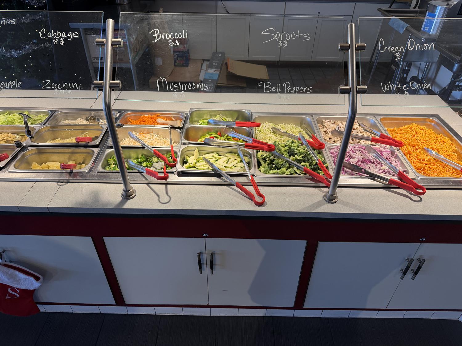 Vegetable ingredient bar with labeled produce at Panda Mongolian BBQ, a Chinese Restaurant in Orange