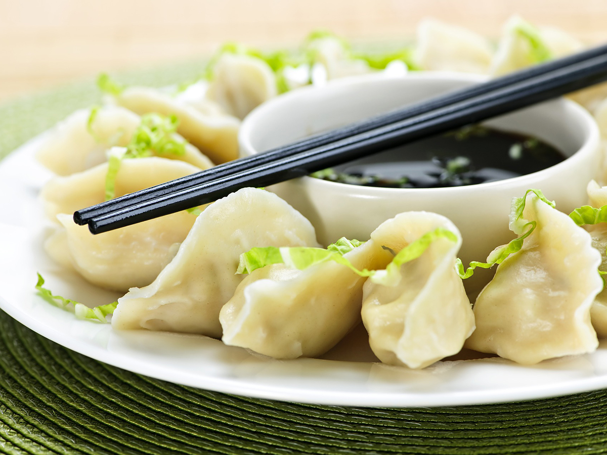 Steamed dumplings on a white plate with vinegar at Panda Chinese Restaurant in Hattiesburg