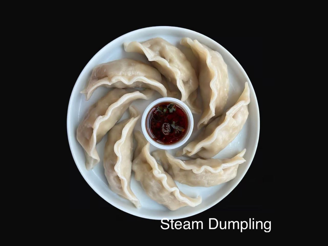 Steamed dumplings with dipping sauce at Pan Pann, a Chinese Restaurant in Livonia