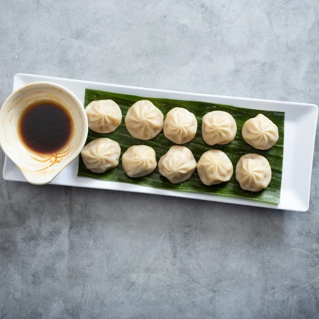 Peony-Chinese-Kitchen-Modern-American-Chinese-Restaurant-Xiaolong-Bao-Laguna-Beach Steamed pork bun Shanghai style. Served with ponzu sauce at Peony Chinese Kitchen,a Modern American Chinese Restaurant in Laguna Beach