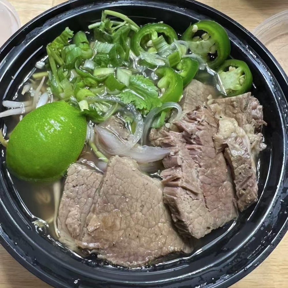 Beef pho with broth, meat, and fresh herbs at PHO 1, a Vietnamese Restaurant in Flanders.