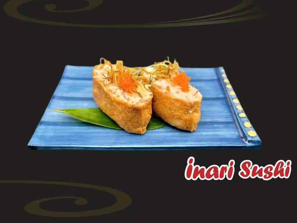 Pho-House-Asian-Fusion-Restaurant-Inari-Sushi-Carmichael Two pieces of savory inari sushi on a blue plate at Pho House, a Asian Fusion Restaurant in Carmichael