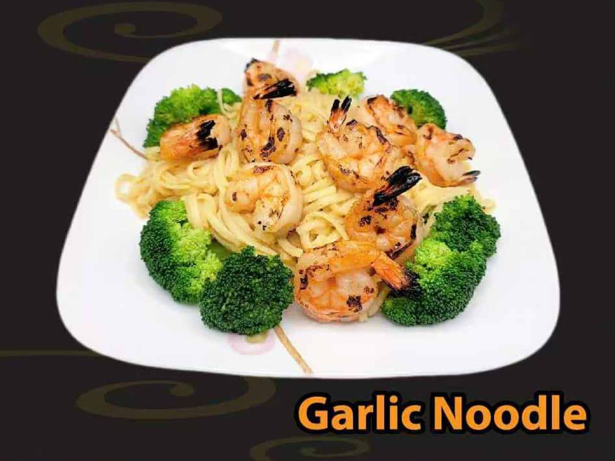 Pho-House-Asian-Fusion-Restaurant-Garlic-Noodle-Carmichael Garlic noodles topped with grilled shrimp and broccoli at Pho House, a Asian Fusion Restaurant in Carmichael