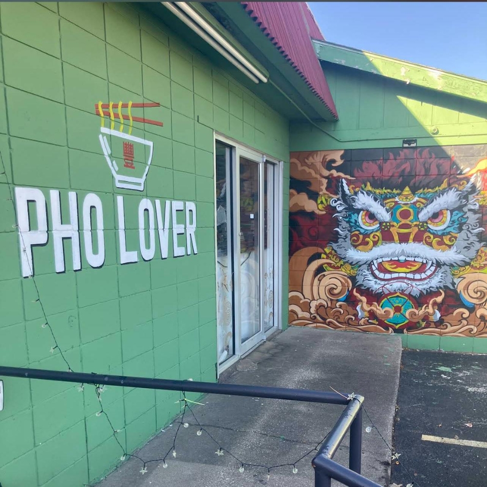 Green storefront with "Pho Lover" sign and vibrant lion dance mural at Pho Lover, a Vietnamese Restaurant in Galesburg