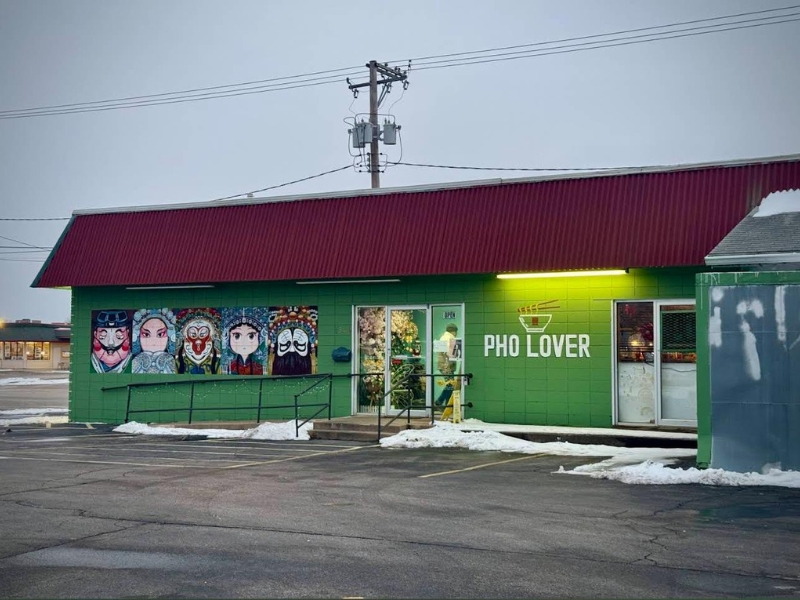 Green storefront with cultural murals and "Pho Lover" sign in snowy parking lot at Pho Lover, a Vietnamese Restaurant in Galesburg