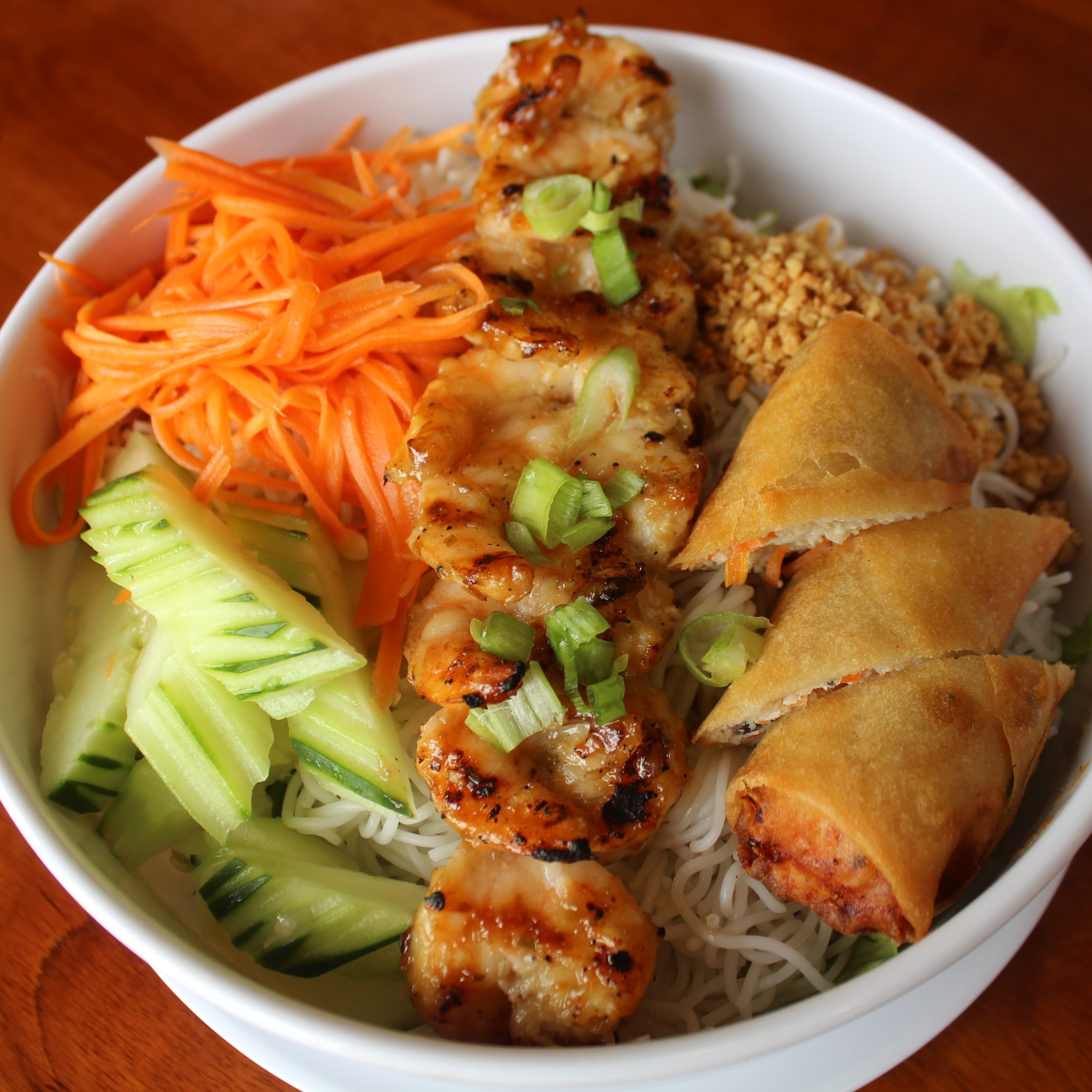 Grilled Shrimp Noodle Bowl - Noodles with grilled shrimp, egg rolls & veggies at Pho Plus 1, a Vietnamese restaurant in Oklahoma City