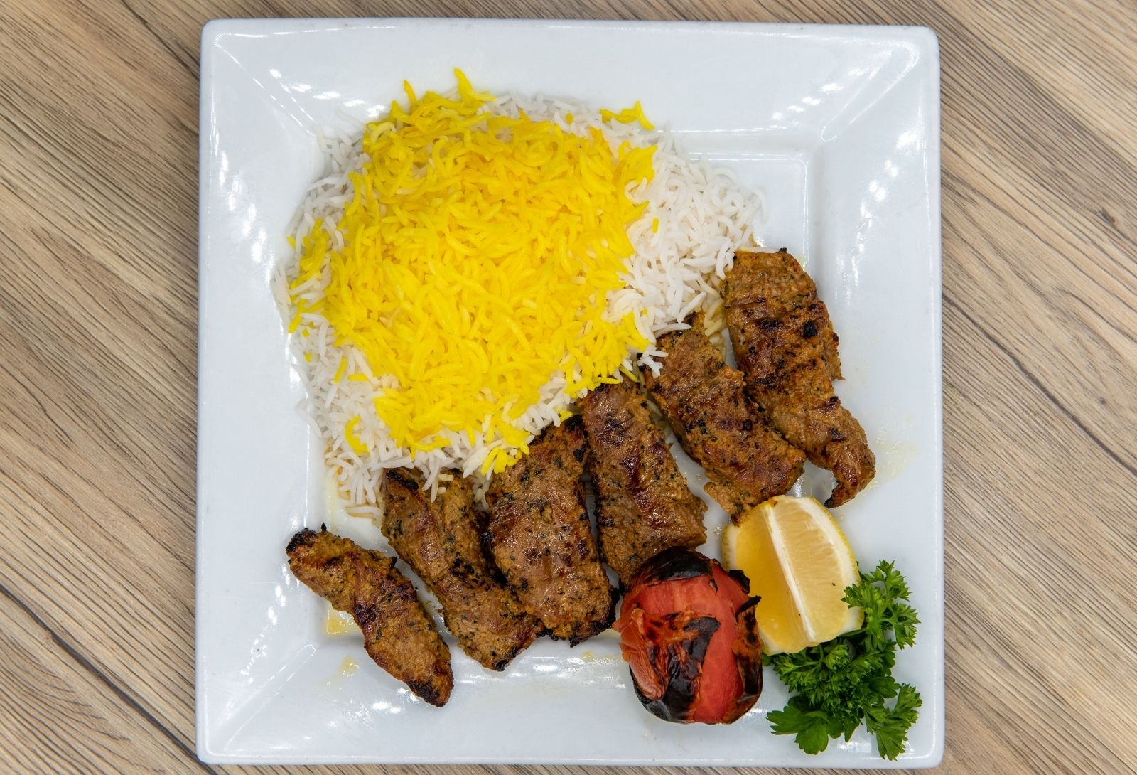 Grilled beef kebab served with saffron rice and lemon wedge at Pho Saigon, a Vietnamese Restaurant in Grand Island